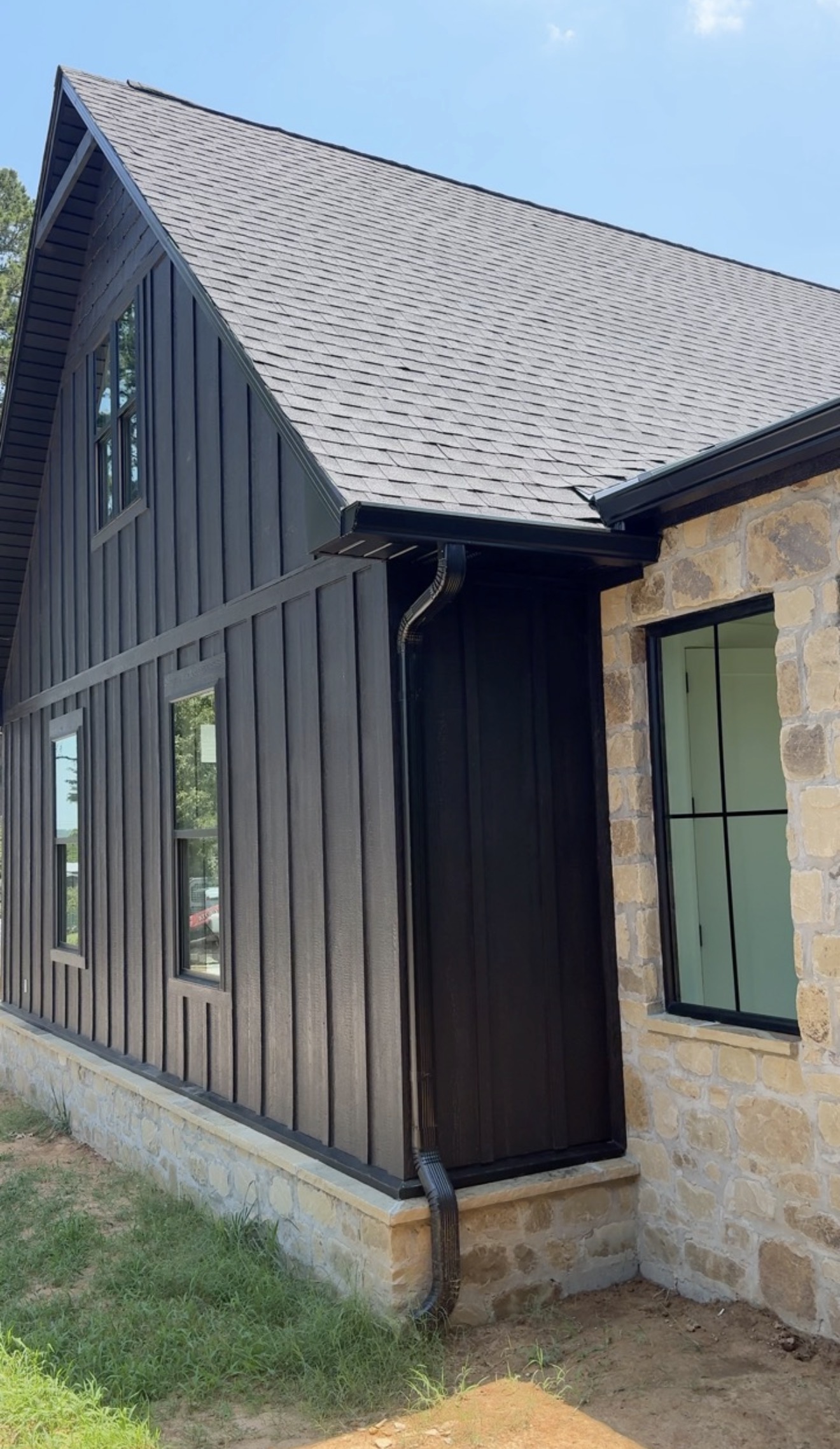 The Market Project charcoal board-and-batten exterior with natural stone